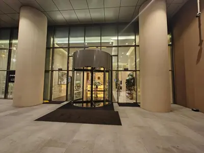 a lobby with a revolving door in a building at LeModCasa: Smart, modern studio in JVC in Dubai