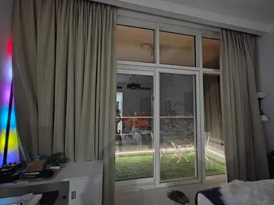 a room with a large window with a view of a yard at LeModCasa: Smart, modern studio in JVC in Dubai