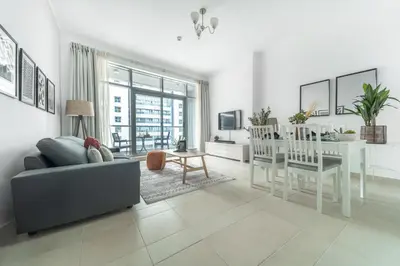a living room with a couch and a dining room at Frank Porter - Torch Tower in Dubai