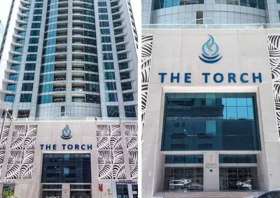 two tall buildings with the torrett logo on them at Frank Porter - Torch Tower in Dubai