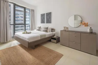 a bedroom with a bed with a mirror and a dresser at Frank Porter - Torch Tower in Dubai