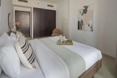 a bedroom with a large white bed with a tray on it at Frank Porter - Torch Tower in Dubai