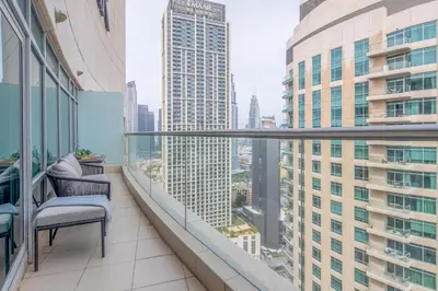 a balcony with a chair and a view of a city at Frank Porter - Burj Views Central Tower in Dubai