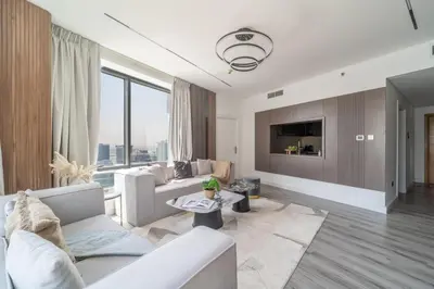 a living room with white furniture and a large window at Frank Porter - Burj Views Central Tower in Dubai