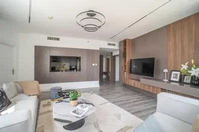 a living room with a couch and a tv at Frank Porter - Burj Views Central Tower in Dubai