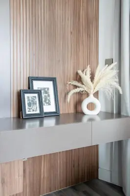 a table with two framed pictures and a plant on it at Frank Porter - Burj Views Central Tower in Dubai