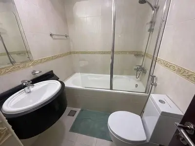 a bathroom with a toilet and a sink and a shower at Ensuite Rooms in CoLiving Apartments in Marina in Dubai