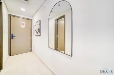 a hallway with two mirrors on the wall at Stylish Studio Apartment at Casa Grande, JVC by Deluxe Holiday Homes in Dubai