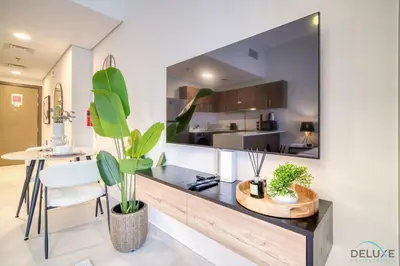 a kitchen with a counter with plants on it at Stylish Studio Apartment at Casa Grande, JVC by Deluxe Holiday Homes in Dubai