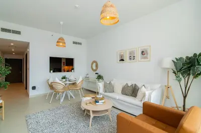 a living room with a couch and a table at Elite Escape Holiday Home - 2 BHK Getaway with Dubai Mall Access - 1503 in Dubai
