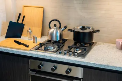 a stove top with two pots and pans on it at Elite Escape Holiday Home - 2 BHK Getaway with Dubai Mall Access - 1503 in Dubai