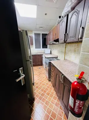 a kitchen with a fire hydrant in the middle of it at Calm Partition Room Near Mashreq Metro in Dubai