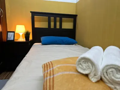 a bedroom with a bed with towels on it at Prime Partition Room in Al Barsha 1 Near Metro in Dubai