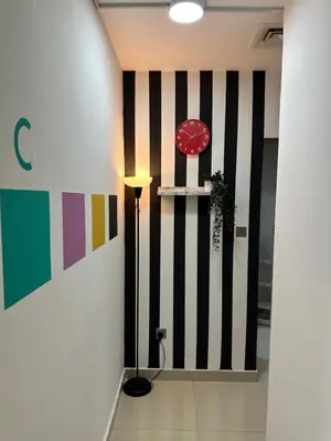 a hallway with a wall with black and white stripes at Individual Partition Room in Al Barsha 1 Near Mashreq Metro in Dubai