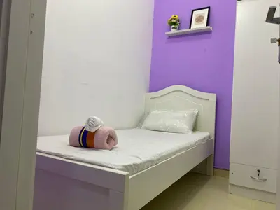 a small bed with a stuffed animal sitting on it at Individual Partition Room in Al Barsha 1 Near Mashreq Metro in Dubai