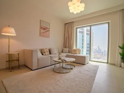 a living room with a couch and a table at Burj Khalifa view Lux 3 bedroom by Tanami Holiday Homes in Dubai