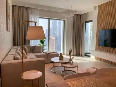 a living room with a couch and a tv at Burj Khalifa view Lux 3 bedroom by Tanami Holiday Homes in Dubai