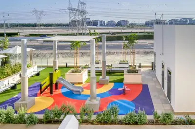 a playground at a school with a slide at Comfortable Studio Apartment at Azizi Riviera 30, Al Merkadh by Deluxe Holiday Homes in Dubai