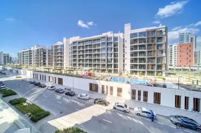 an aerial view of a parking lot in front of buildings at Comfortable Studio Apartment at Azizi Riviera 30, Al Merkadh by Deluxe Holiday Homes in Dubai