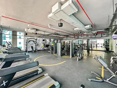 a gym with several treadmills and exercise bikes at Summer offer! All Inclusive! Prime Location in Dubai