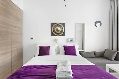 a bedroom with a large bed and a couch at Summer offer! All Inclusive! Prime Location in Dubai