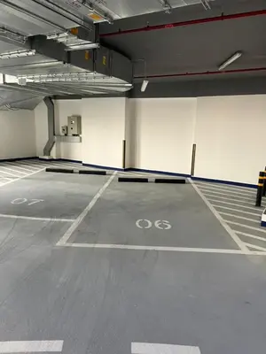 an empty parking lot with a bike painted on it at Spacious Balcony, King Bed, Pool at JVC Dubai in Dubai