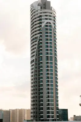a tall building with a lot of windows at Spacious Balcony, 1BR, Pool, Full Kitchen at JVC in Dubai
