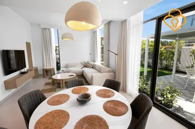 a living room with a table and a couch at Keysplease Wonderful 4 B/R Home with Garden Arabian Ranches in Dubai