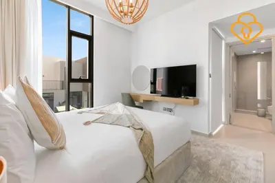 a white bedroom with a large bed and a tv at Keysplease Wonderful 4 B/R Home with Garden Arabian Ranches in Dubai