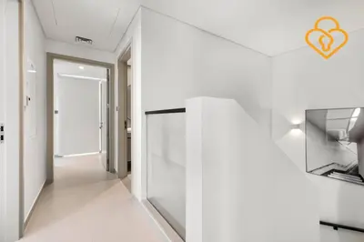 a hallway with white walls and a hallway with an open door at Keysplease Wonderful 4 B/R Home with Garden Arabian Ranches in Dubai