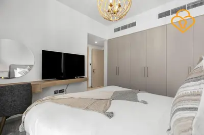 a bedroom with a bed and a flat screen tv at Keysplease Wonderful 4 B/R Home with Garden Arabian Ranches in Dubai