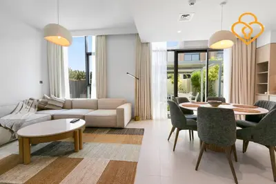 a living room with a couch and a table and chairs at Keysplease Wonderful 4 B/R Home with Garden Arabian Ranches in Dubai