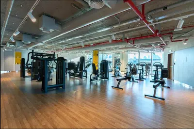 a gym with lots of treadmills and machines at Stunning 2 Bedroom Apartment with Burj Views by Zen Stays - Walking Distance to Dubai Mall in Dubai