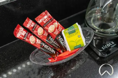 a bowl filled with packets of toothpaste and chips on a counter at Oraya - Paramount Midtown Luxurious 2BR with Sea View in Dubai