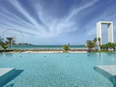 a pool with a view of the beach and the washington monument at La Vie, JBR - Cosy Two Bedroom in Dubai