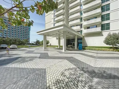 a person walking in front of a building at La Vie, JBR - Spacious One Bedroom in Dubai