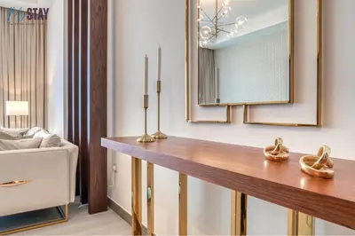 a living room with a table and a mirror at Luxurious Two-Bedroom Apartment in Dubai
