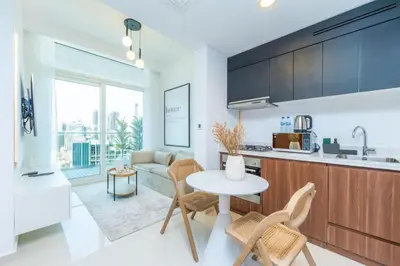 a kitchen and living room with a table and chairs at The Dreamer 1BR Burj Khalifa View Business Bay in Dubai