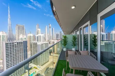 a balcony with a table and chairs and a view of the city at The Dreamer 1BR Burj Khalifa View Business Bay in Dubai