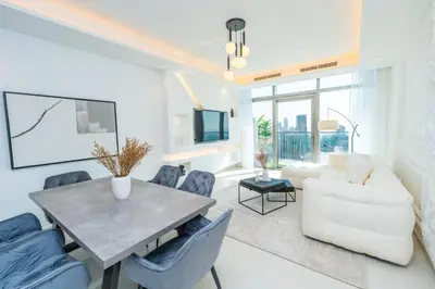 a living room with a table and a couch at The Cinephile Burj Khalifa View 2BR Dubai in Dubai