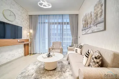 a living room with a couch and a table at Serene 1BR Apartment in Azizi Riviera 27, Al Merkadh by Deluxe Holiday Homes in Dubai