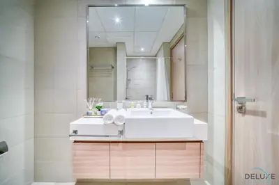 a bathroom with a white sink and a mirror at Serene 1BR Apartment in Azizi Riviera 27, Al Merkadh by Deluxe Holiday Homes in Dubai