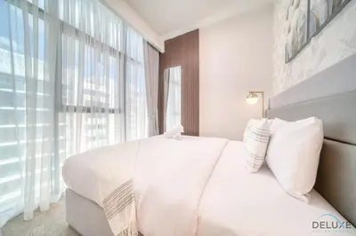 a bedroom with a white bed and a large window at Serene 1BR Apartment in Azizi Riviera 27, Al Merkadh by Deluxe Holiday Homes in Dubai