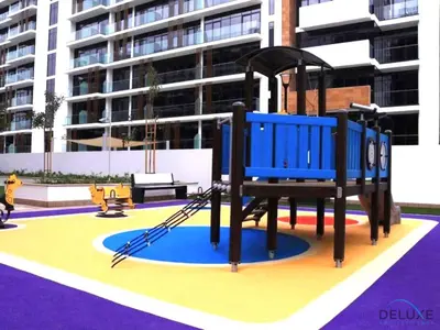 a playground in front of a building at Serene 1BR Apartment in Azizi Riviera 27, Al Merkadh by Deluxe Holiday Homes in Dubai