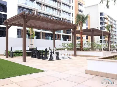 a chess game in a park with a giant chessboard at Serene 1BR Apartment in Azizi Riviera 27, Al Merkadh by Deluxe Holiday Homes in Dubai