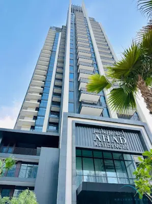 a tall building with a sign on it at Welcoming 1BR Apartment in Ahad Residences Business Bay by Deluxe Holiday Homes in Dubai