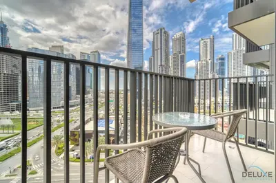 a balcony with a table and chairs and a view of the city at Welcoming 1BR Apartment in Ahad Residences Business Bay by Deluxe Holiday Homes in Dubai
