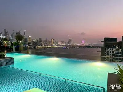 a large swimming pool on the roof of a building at SEVEN PALM by Design Studio 1BR in Dubai