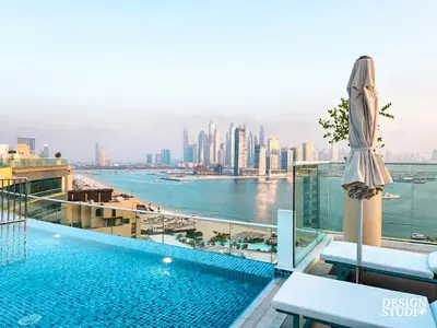 a swimming pool on top of a building with a city at SEVEN PALM by Design Studio 1BR in Dubai