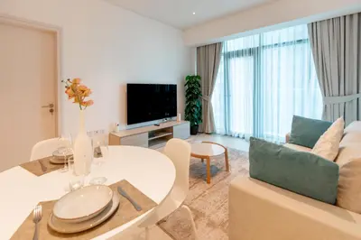 a living room with a couch and a table at SEVEN PALM by Design Studio 1BR in Dubai